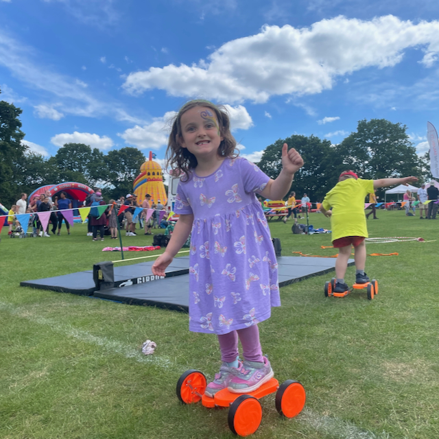 Circus skills instruction for children at a fete